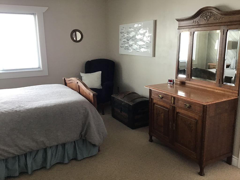 Main level bedroom with antique furnishings.