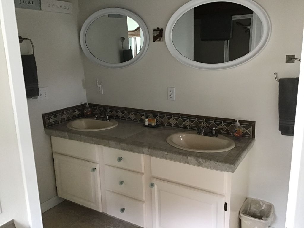 Main level bathroom with double sinks. Bathroom has a shower/tub.