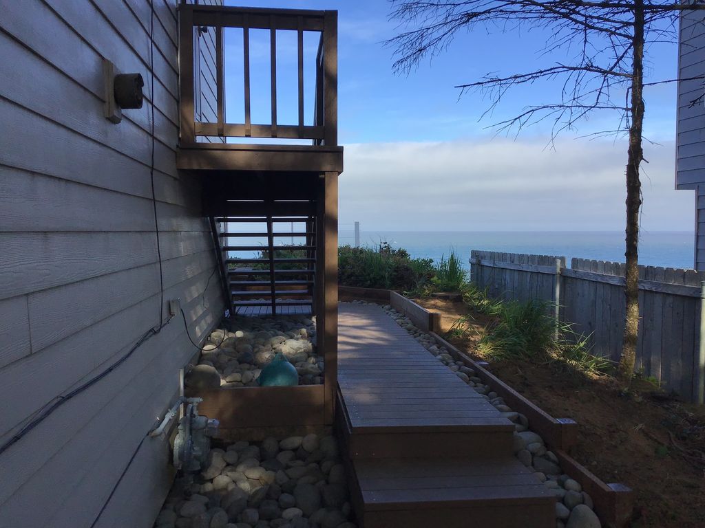 View from the driveway on north side of house; walkway to the ocean front deck.