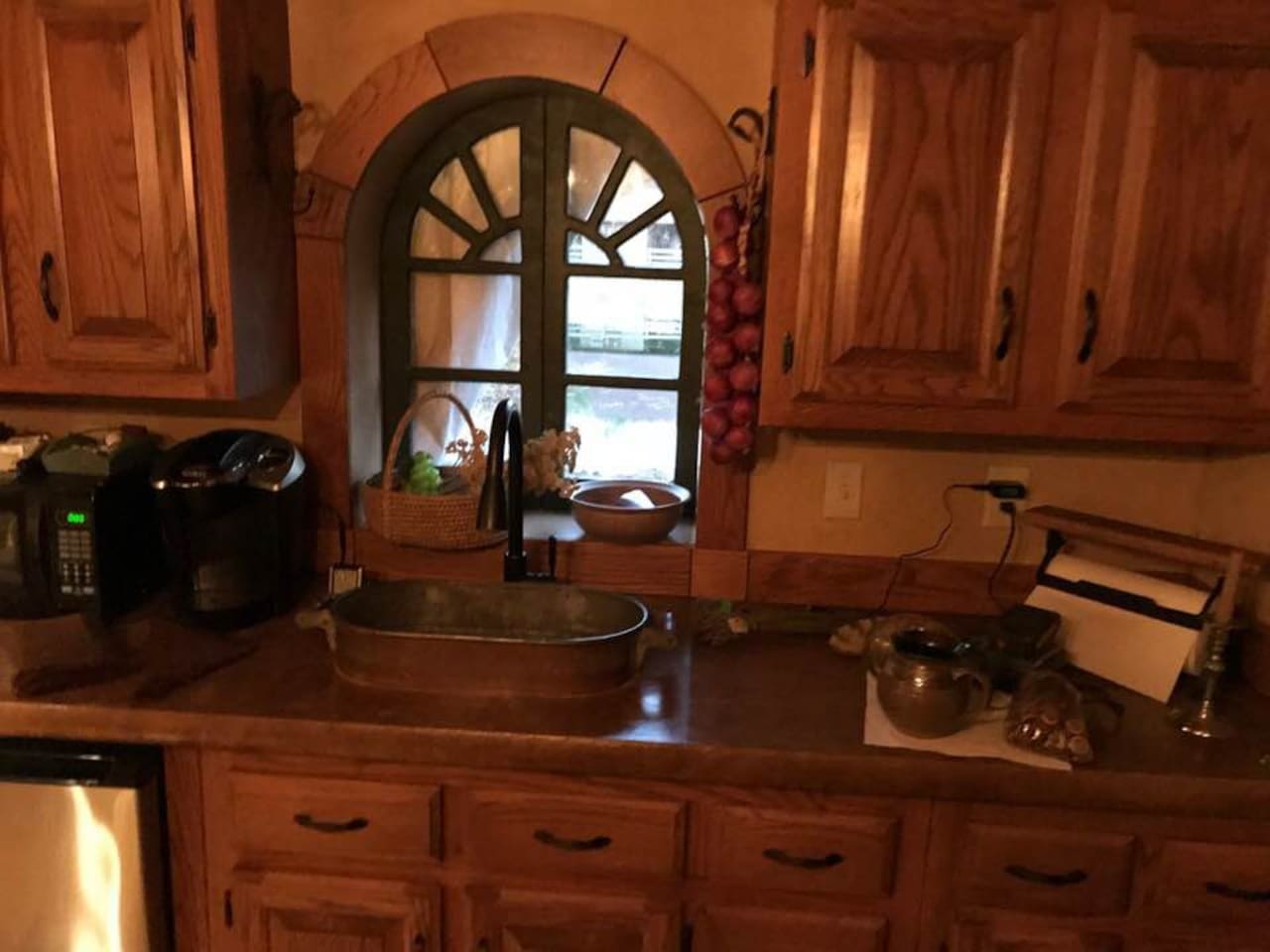 Concrete counter-top, microwave, K-cup coffee maker, Frig and vintage cooker used as a sink. All wood for trim and cabinetry were selectively harvested from our farm!
