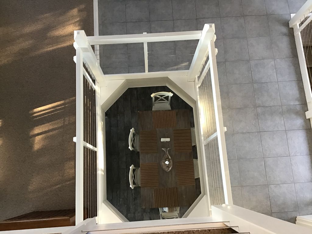 View from the loft area to the kitchen/dining room table on the main floor.