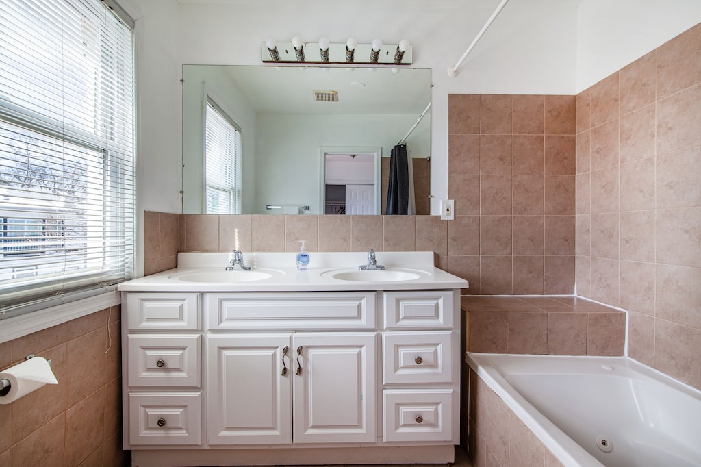 Primary Bathroom With Double Sink and Jacuzzi Tub