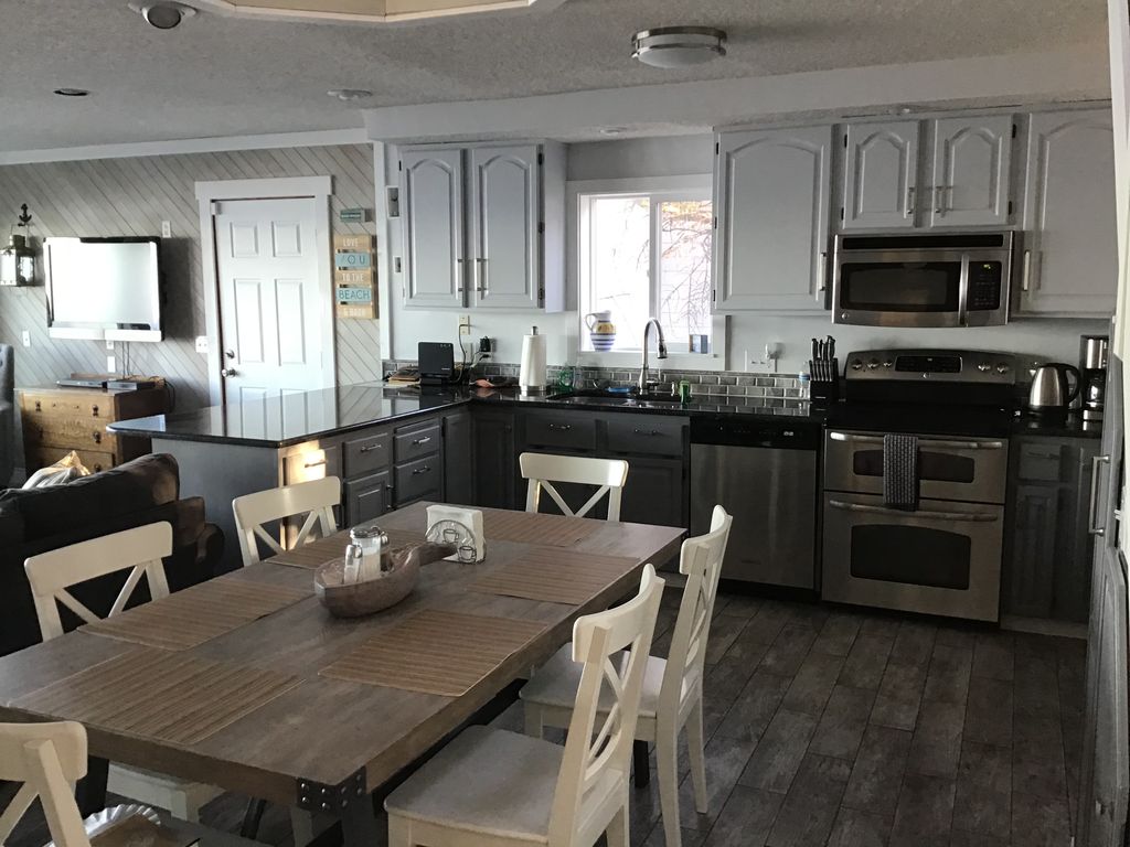 Main level Kitchen and Dining area. There is a Kitchen Bar with seating for 4.